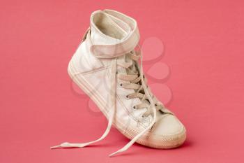 White leather shoe on the pink background
