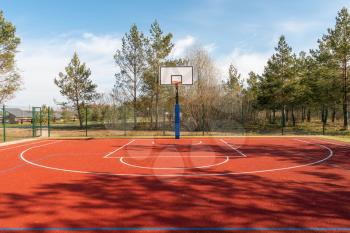 An empty basketball court found in the outdoors during spring season