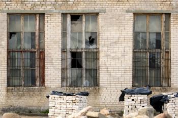 Broken windows in an old abandoned industrial building