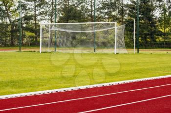 Outdoor athletics treadmill running track with behind soccer gate