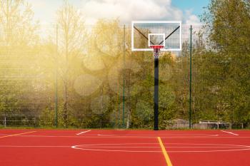 Basketball court in school stadium during spring season