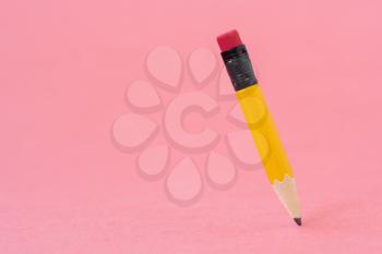 Sharp pencil with eraser on the pink background