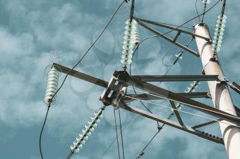 Close-up of high voltage tower with electricity transmission power lines