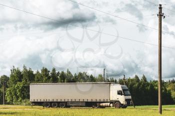 Road transport of goods by truck.Truck driving on the asphalt road in rural landscape 