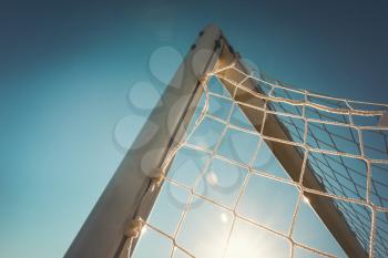 Top corner of a football goal in the sunset time