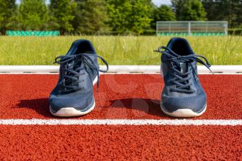Sport shoes on racetrack. Sport and running concept.