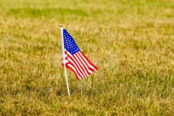 Small American flag on grass lawn. Memorial day US flags. Labor day concept. Happy Independence Day.