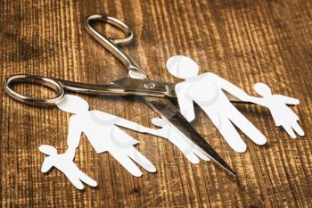 Scissors cutting paper cut of family. Broken family concept ,divorce