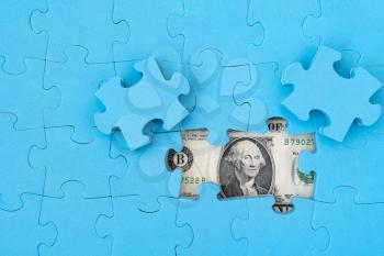 Dollar puzzle, business concept of solution. Dollar bill and puzzle pieces. Portrait of american president Washington