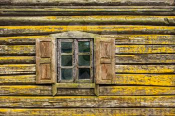 Old wooden log house,window with open shutters