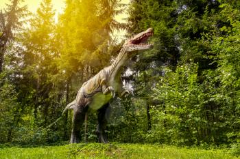 Statue of realistic prehistoric dinosaur in a woods