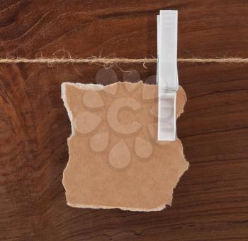 Card on the rope over wooden background