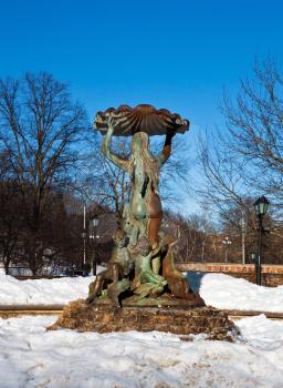 Female sculpture fountain in winter near the Latvian national opera