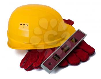 Building helmet, gloves and level isolated on white
