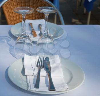 Restaurant table with glass plate and silverware