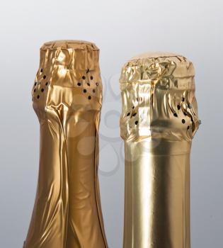 Top of two champagne bottles