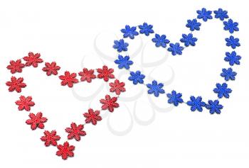 Two red and blue hearts from snowflakes on white 