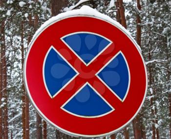 Road sign- no parking on the winter forest