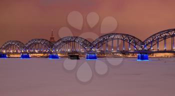 Riga railway bridge at night time in winter
