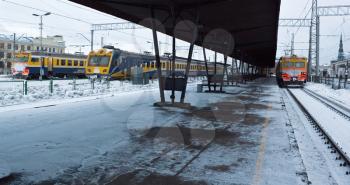 Railway station with three trains in winter