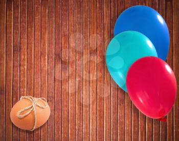 Easter egg withballoons on wooden background