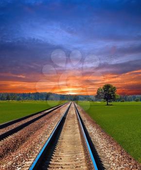 Railway in field on beautiful summer evening