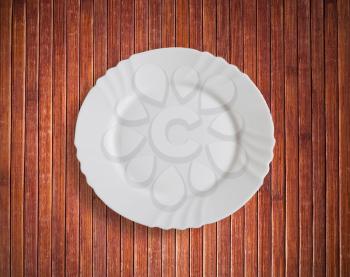 Plate on wooden plank background