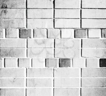 Old weathered brick white wall
