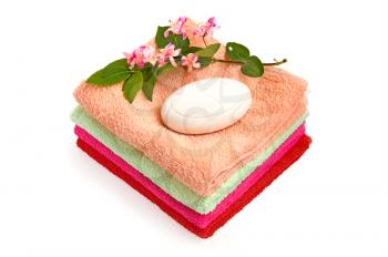 Royalty Free Photo of Soap and Flowers on a Stack of Towels