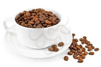 Coffee grains in a white cup, on a saucer and on the table isolated on a white background