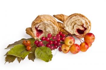 Two halves of croissants with red jam, viburnum berries and hawthorn, wild apples, green leaves isolated on white background