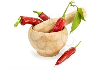 Three fresh chilli pepper with a green leaf in a wooden bowl and a pepper on the table isolated on white background