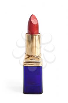 Red lipstick in a blue and gold shell isolated on white background