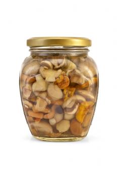 Assorted marinated mushrooms in a glass jar isolated on white background