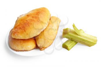 Golden patties on a plate, green stalks of rhubarb is isolated on a white background