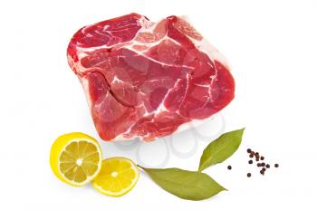 Piece of pork, lemon, two laurel  leaf and black pepper isolated on white background