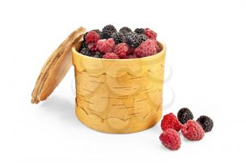 Red raspberries and blackberries in a bowl  from birch bark isolated on white background