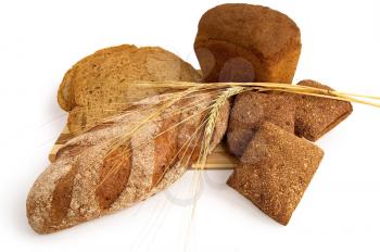 Various rye bread with a wooden board with stems of rye isolated on a white background