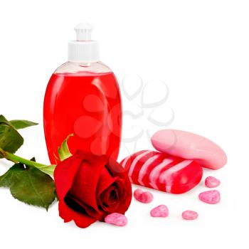 Red liquid soap in a bottle, solid striped red and pink soap, bath salt, red rose isolated on white background
