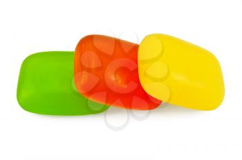 Three pieces of soap in yellow, red and green isolated on white background