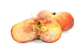 One whole and half red-yellow flat peaches isolated on white background