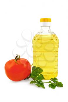 Vegetable oil in a bottle with a sprig of parsley and red ripe tomatoes isolated on white background