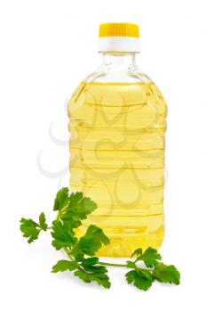 Vegetable oil in a bottle with a sprig of parsley is isolated on a white background