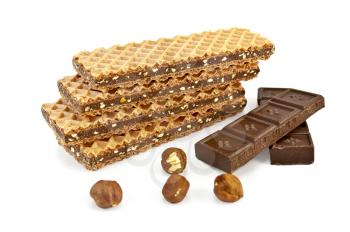 A stack of waffles, interlayered with chocolate, two bars of chocolate and four nuts isolated on white background