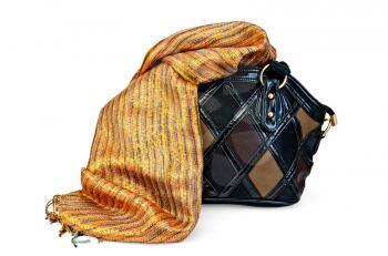 Leather female bag with orange silk scarf isolated on white background