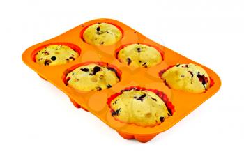 Six cupcakes with berries in orange silicone mold isolated on white background