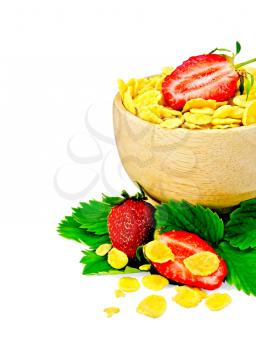 Corn flakes in a wooden bowl with half a strawberry, leaves and berries of a strawberry isolated on a white background