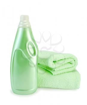 Green fabric softener in the bottle and two green towels isolated on white background