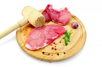 Repulsed a piece of meat, garlic, pots of different peppers, fennel, wooden mallet on a circular wooden board isolated on white background
