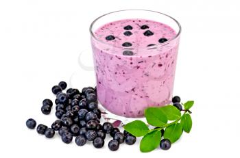 The glass of milkshake and blueberries, berries and green sprig of blueberries isolated on white background